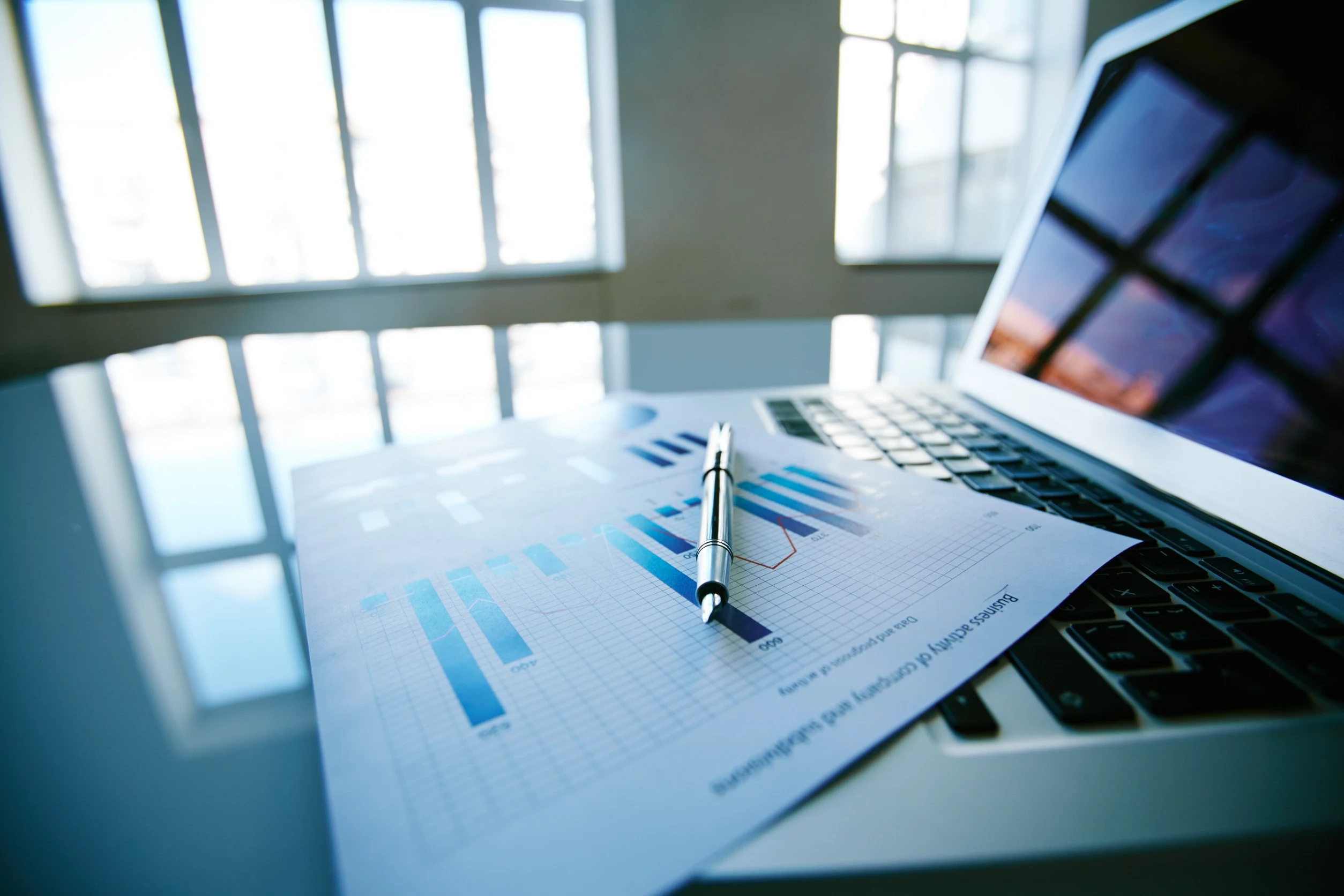 Close-up of financial report left on keyboard